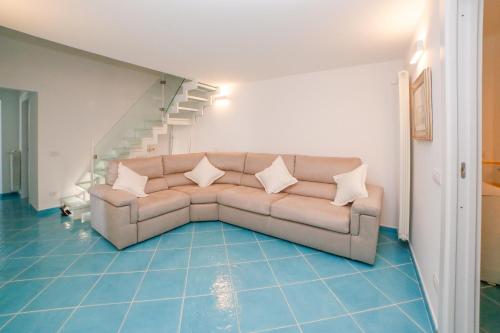 a living room with a couch and a staircase at Amalfi Dream Charming House in Scala