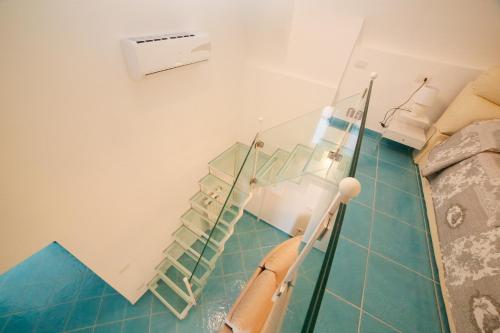 a hospital room with a glass staircase in a room at Amalfi Dream Charming House in Scala