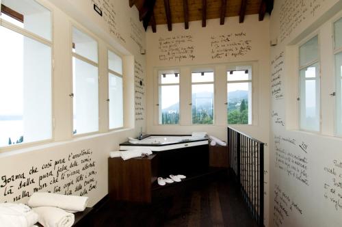 a bathroom with writing on the walls and a sink at Hotel Villa Del Sogno in Gardone Riviera