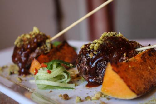 a plate of food on a table with food with chopsticks at Erinvale Estate Hotel & Spa in Somerset West