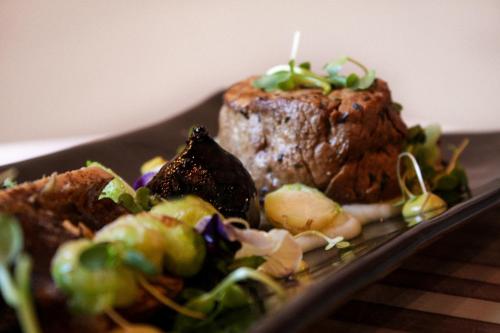 a plate of food with a steak and a salad at Erinvale Estate Hotel & Spa in Somerset West