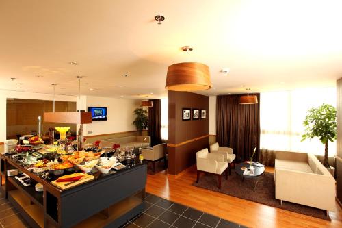 a living room with a table full of food at Liberty Central Saigon Centre Hotel in Ho Chi Minh City