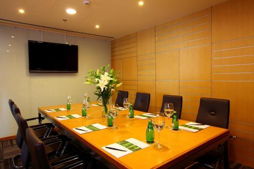 a conference room with a long wooden table and chairs at Liberty Central Saigon Centre Hotel in Ho Chi Minh City