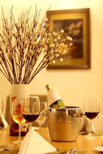 a table with wine glasses and a bottle of wine at Liberty Central Saigon Centre Hotel in Ho Chi Minh City