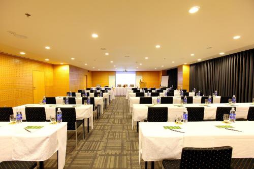 a banquet hall with white tables and chairs at Liberty Central Saigon Centre Hotel in Ho Chi Minh City