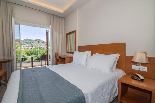 Postel nebo postele na pokoji v ubytování Hotel Palmyra