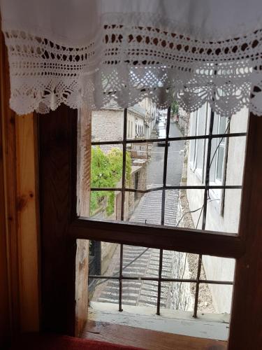 an open window with a view of a street at Eva Guesthouse in Gjirokastër