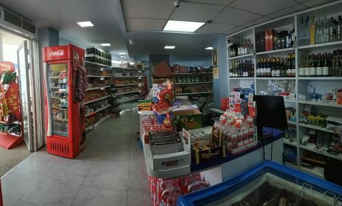 a store aisle of a grocery store with a soda machine at Hotel Apartment Short Term Tel Aviv Bat Yam 5 in Bat Yam