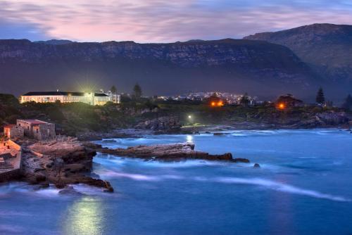 a view of a river at night with mountains at The Marine Hermanus in Hermanus