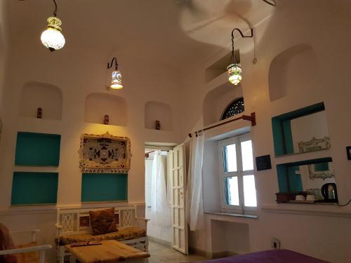 a room with two lights and a table and a window at Inn Seventh Heaven in Pushkar