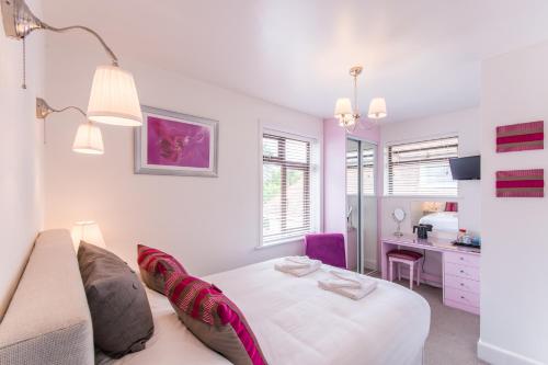 a living room with a bed and a desk at The Mariners Guest House in Poole