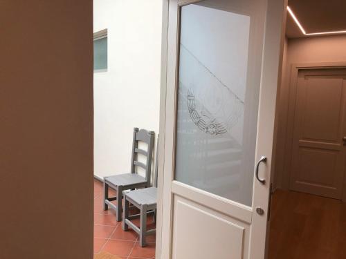 a door leading into a room with a chair at Palazzo Vasarri - Luxury design suites in Montevarchi