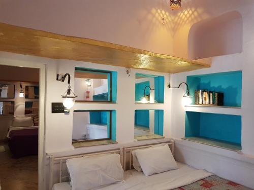 a room with two chairs and two mirrors at Inn Seventh Heaven in Pushkar