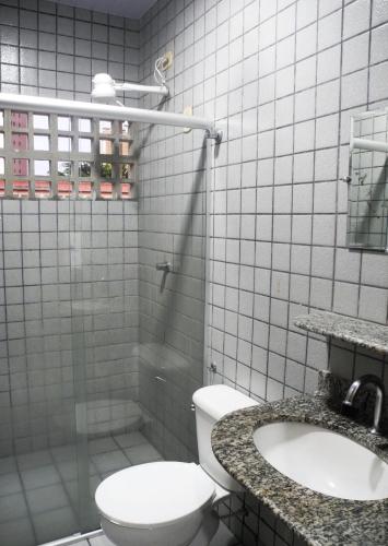 a bathroom with a toilet and a sink at Praia Apart Hotel in Natal