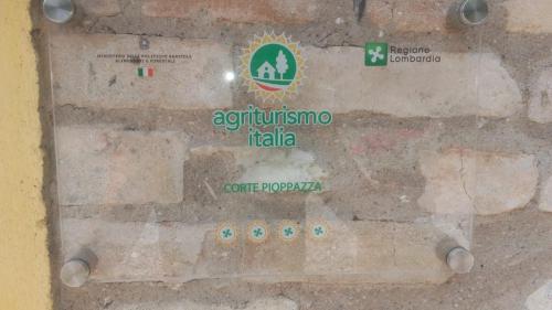 a stone wall with different signs on it at Corte Pioppazza in Ceresara