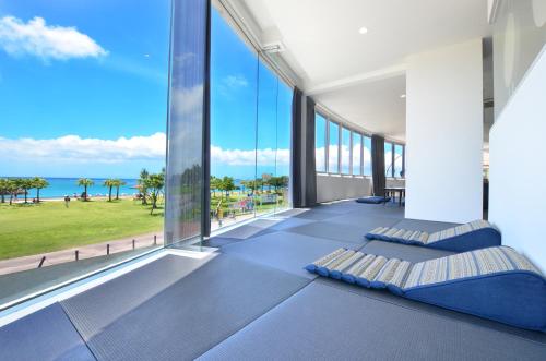 a bedroom with a view of the ocean at Araha Resort Arapana in Chatan