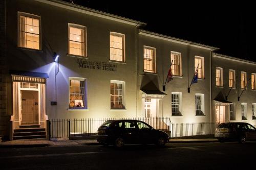 a black car parked in front of a building at night at Mantis St Helena in Jamestown