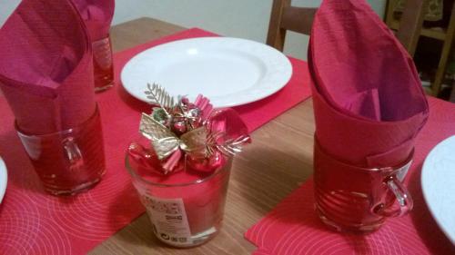 a table with a pink table cloth and a pair of high heels at Stephanie Home in Padova