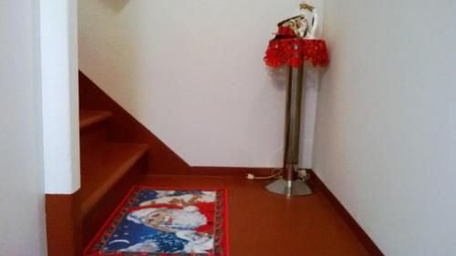 a stairwell with a vase of flowers and a carpet at Stephanie Home in Padova