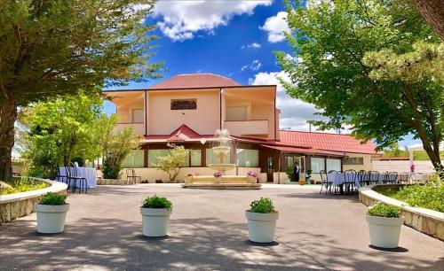 a building with tables and chairs in a courtyard at Antico Resort Cerasella in Petralia Soprana