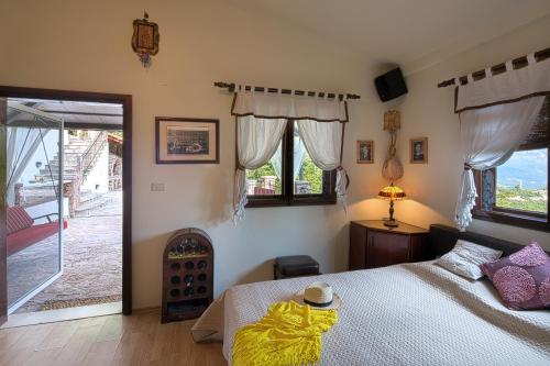 a bedroom with a bed with a yellow blanket on it at Holiday Home La Musica in Budva