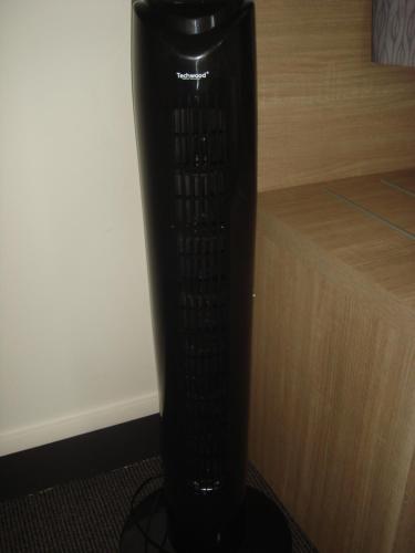 a black vase sitting next to a wooden wall at The Originals City, Hôtel Le Savoy, Caen in Caen