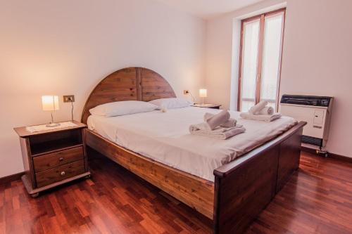 a bedroom with a large bed with a wooden headboard at Il mulino in Varenna