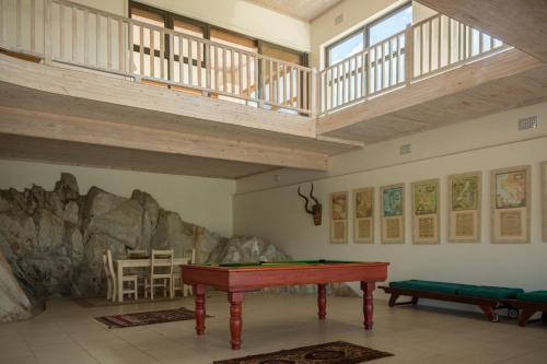 a ping pong table in a room with a ceiling at Barton Luxury Villas in Botrivier