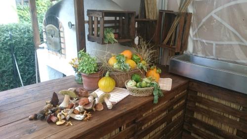 a bunch of vegetables sitting on a wooden table at Hotel Restaurant Denis in Zemmer