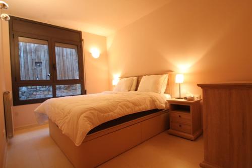 a bedroom with a bed and a window at Salze, Canillo, Zona Grandvalira in Canillo