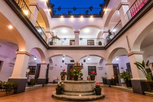 a large building with a fountain in the middle at Hotel del Marquesado in Oaxaca City