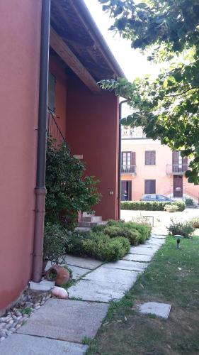 a building with a walkway in front of a building at Agriturismo Cascina Palazzo in Roddi