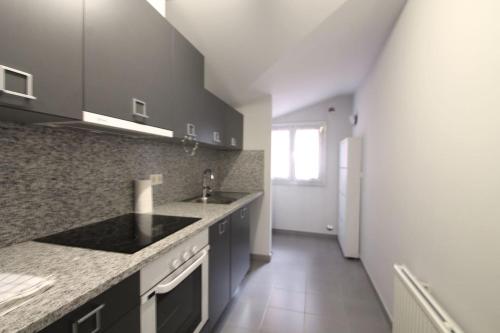 a kitchen with a sink and a counter top at Av Carlemany, Centro comercial in Escaldes-Engordany