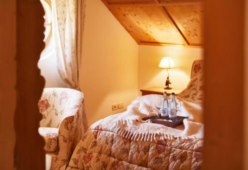 a bedroom with a bed with a table and a lamp at Schlosswirt Forst in Lagundo