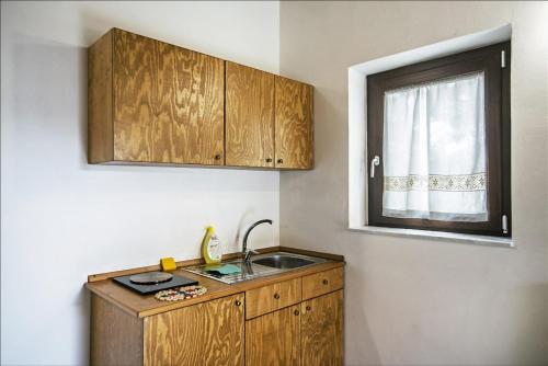 a small kitchen with a sink and a window at Antico Resort Cerasella in Petralia Soprana