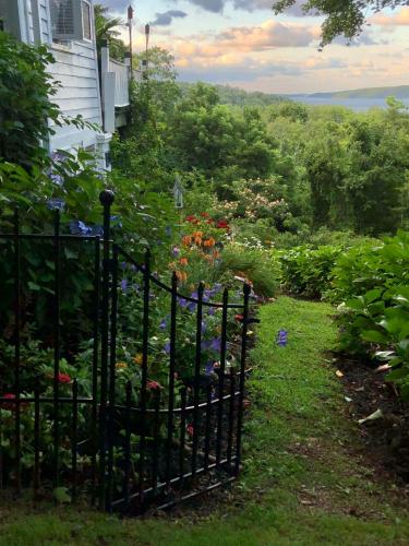 a garden with a black fence and flowers at Renwick Clifton House B&B in Saugerties