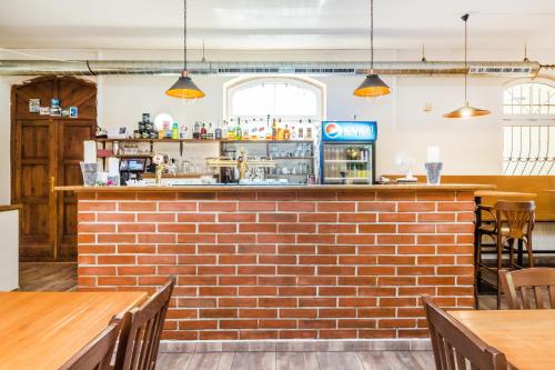 a brick bar in a restaurant with tables and chairs at Nová Hospoda - Hotel & Restaurant in Prague