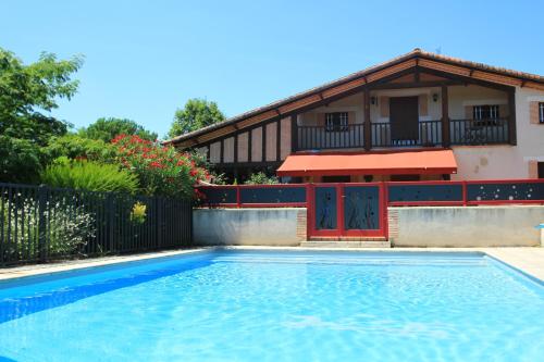 a house with a swimming pool in front of a house at le mas des cerisiers le temple sur lot in Le Temple-sur-Lot