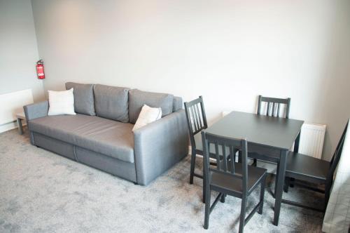 a living room with a couch and a table at The Square Guest Apartment in Stewartstown