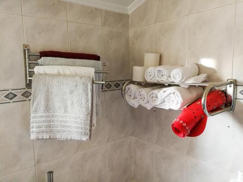 a bathroom with a towel rack with towels at POMBALINO! Lisbon Concept Apartments in Lisbon