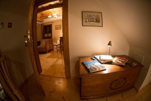 a room with a desk and a hallway at Pensjonat Dom Zegarmistrza in Bogatynia