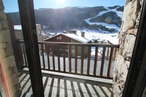a balcony with a view of a snow covered mountain at Julia, el Tarter, zona Grandvalira in El Tarter