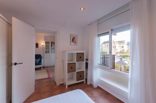 Dieses weiße Zimmer verfügt über ein großes Fenster und einen Balkon. in der Unterkunft Lets Holidays apartment Sa Coma 2 in Tossa de Mar