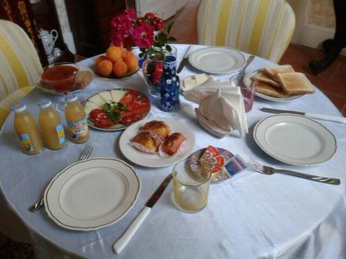 a white table with plates of food on it at B&B Domenico Cesarelli in Arena
