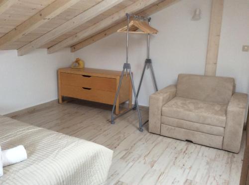 a bedroom with a bed and a chair and a desk at Marina in Nikiti