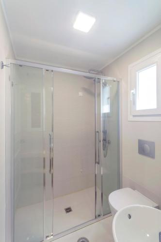 a bathroom with a shower with a toilet and a sink at Samos Sun in Pythagoreio