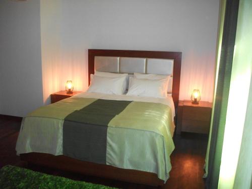 1 dormitorio con 1 cama grande y 2 mesitas de noche en Casa Deus en Sabrosa