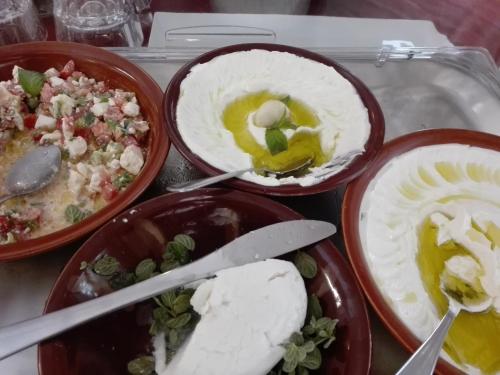 four bowls of food on a tray with food at The Grand Meshmosh Hotel in Beirut