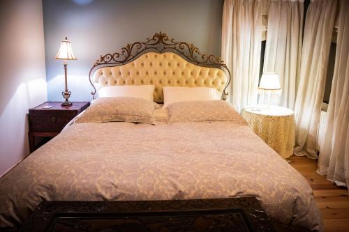 a bedroom with a large bed and two lamps at Villa in the mountain in Ioannina
