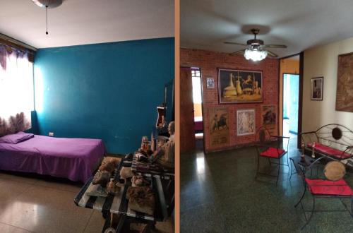 a room with a bed and a blue wall at Urban Rent Habitación Familiar in Caracas